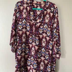 Maroon, patterned blouse with half sleeves.